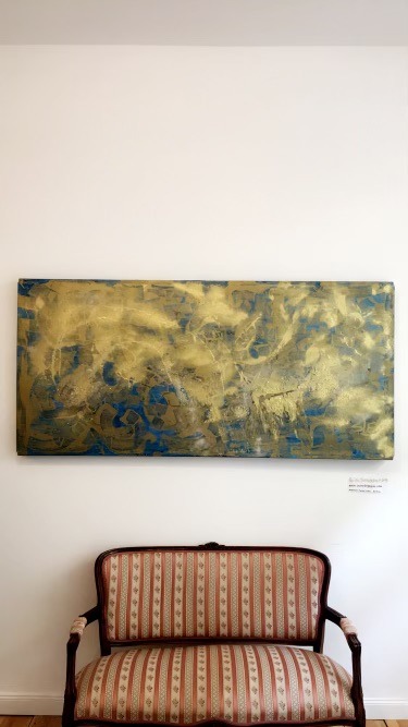Berlin Thunderstorm Sunny Side Up Passing Over The Pacific Ocean, gold and blue painting by Sarah Edgehill, on a gallery wall
